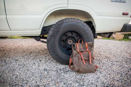 backpack bag outdoors car tire