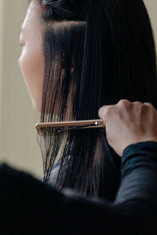 Stylist Combs Through Long Hair Photo