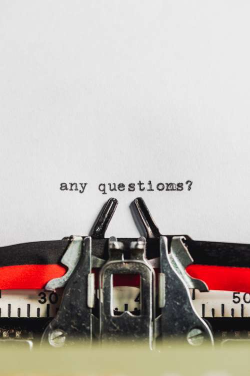 Text On Typewriter Asks 'Any Questions?' Photo