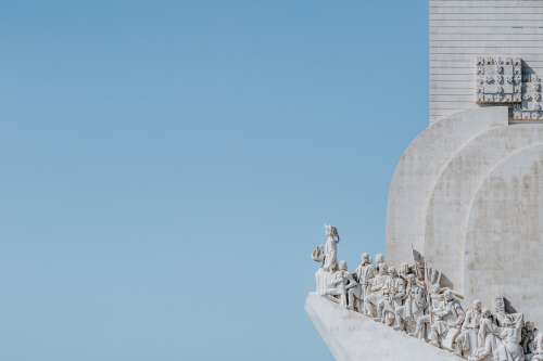 A Group Of Statues On The Edge Of White Stone Building Photo