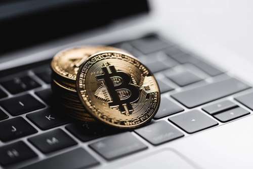 Gold Bitcoin Coins on Laptop Keyboard Free Photo