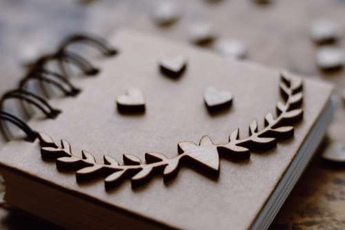 Wooden heart decorations on a notebook