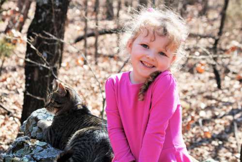 Little Girl And Cat In The Woods