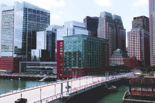 city buildings bridge shore ocean