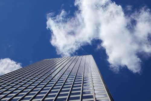 city building windows sky clouds