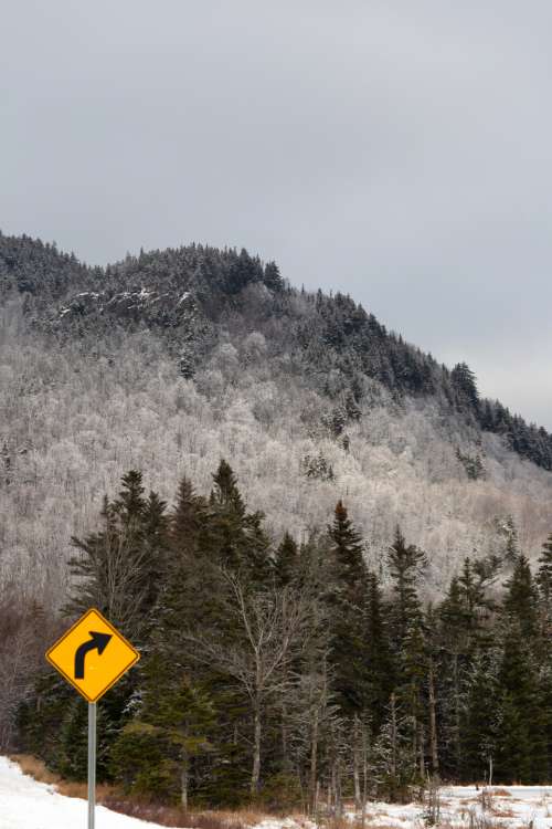 road sign mountains winter travel