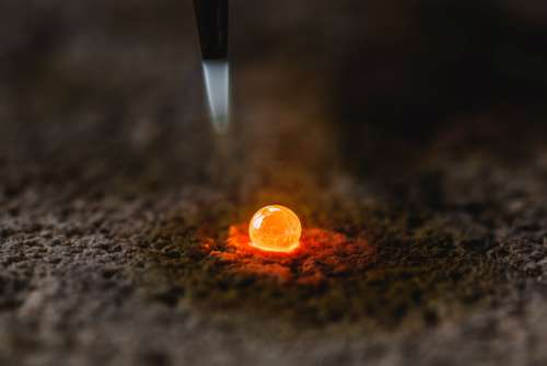 Molten Metal Drop On Bed Of Ash Photo