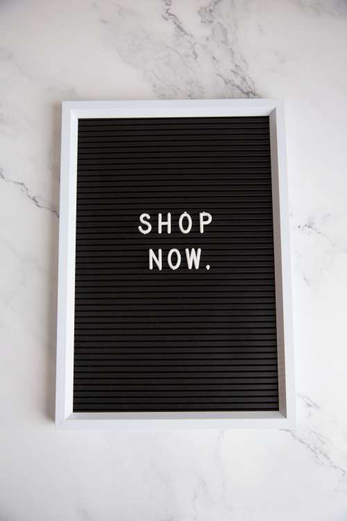 Shop Now Sign On Marble Photo