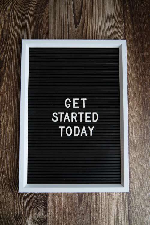 Get Started Today On Dark Wood Background Photo