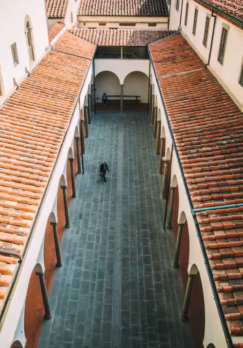 Man Walks Through Narrow Courtyard Photo