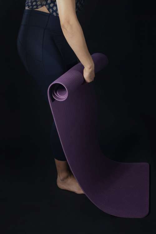 Woman Rolls Yoga Mat Photo