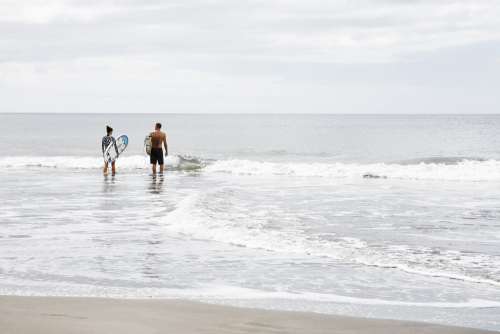 Couple Ready To Surf Photo