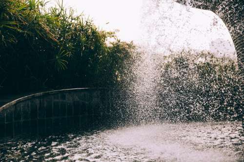 Cascading Water Splashes Into A Fountains Pool Photo