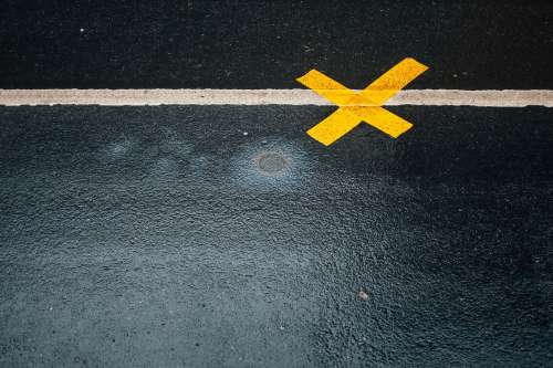 A Yellow X On Asphalt Photo