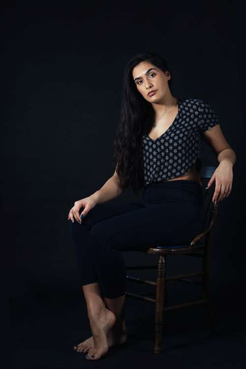 Woman Sitting On Wooden Chair Photo