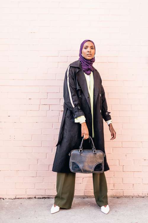 Stylish Model Poses Holding Leather Handbag Photo