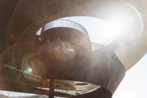 Sun Rays Through A Spiraled Stair Case Photo