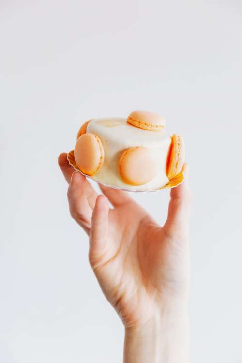 Hand Holding Small Cake Photo