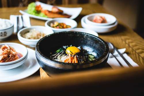 Traditional Korean Bibimbap vegetables with raw egg yolk