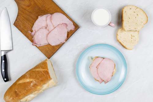 Simple breakfast of white bread and cold meat cuts