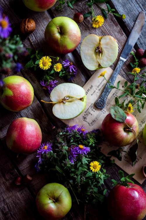 Apples and flowers on desk