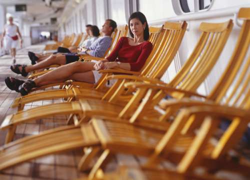 Woman relaxing in deck chair on cruise ship, portrait