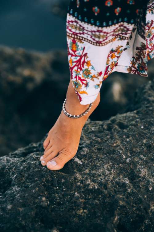 female foot fashion rocky shore