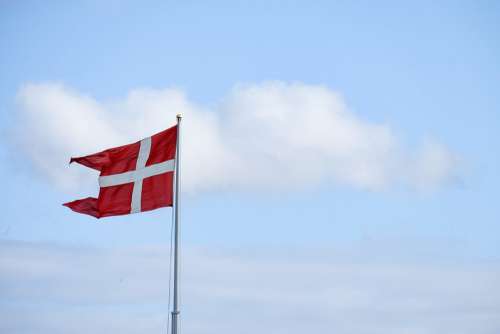 Denmark Flag With Cloudy Sky in Background