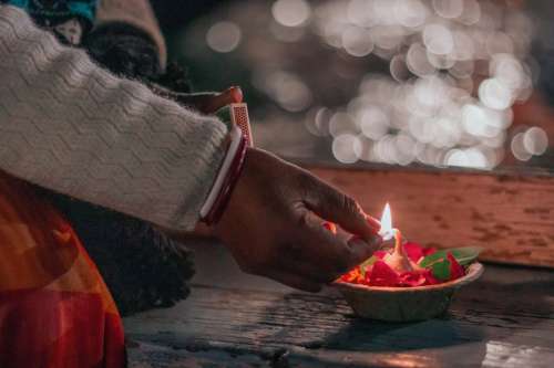 A Man Lights The Wick Of A Aarti Photo