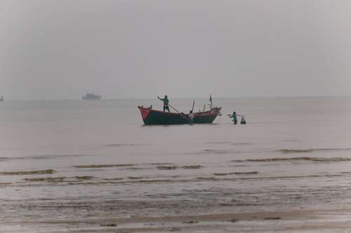 Fishermen On The Shoreline Photo