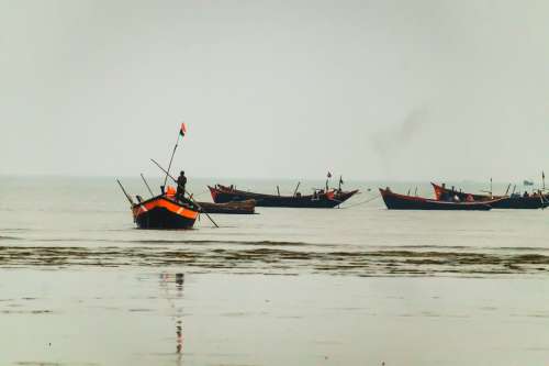 Fishing Boats Grouped On The Water Photo