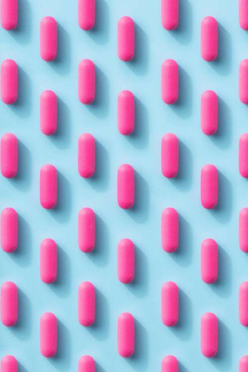 Pink Pill Pattern On A Blue Background Photo