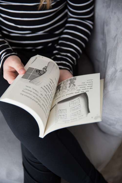 A Young Girl Flips The Page Photo