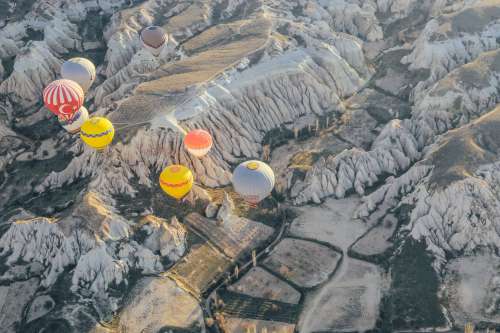 Hot Air Balloons Over Rocky Landscape Photo