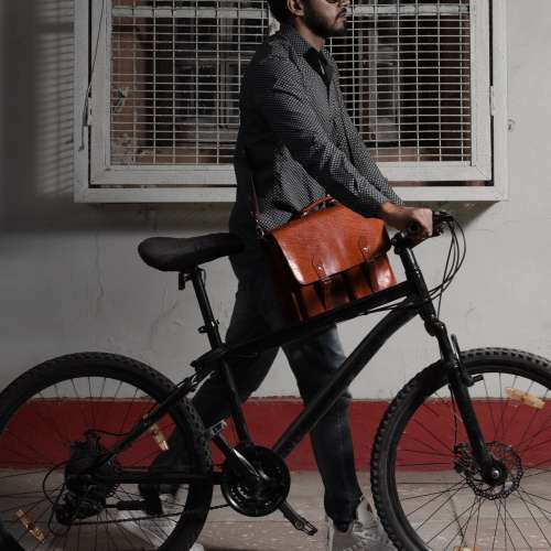 Man Biking With Leather Messenger Bag Photo