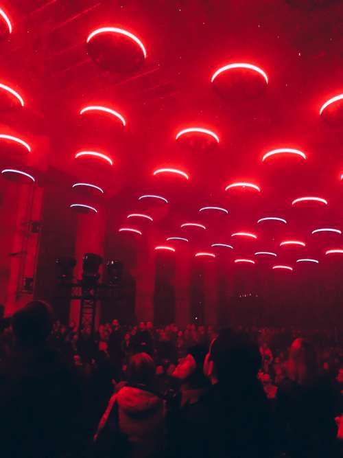Circular Red Lights Above Crowd Photo