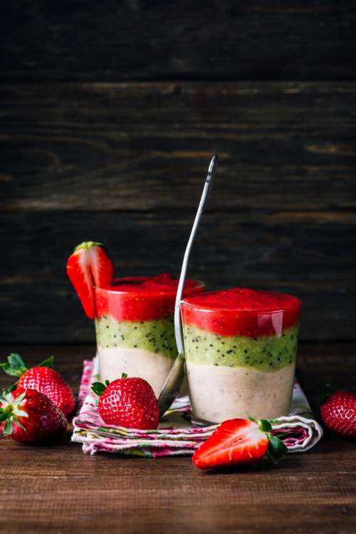 Smoothie from banana, kiwi, and strawberry on a wooden background