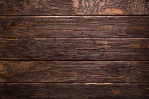 Close up of horizontal rough dark wood board texture