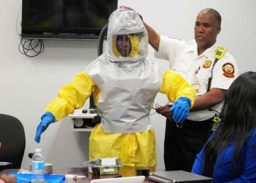 Police and Person in Contamination Suit