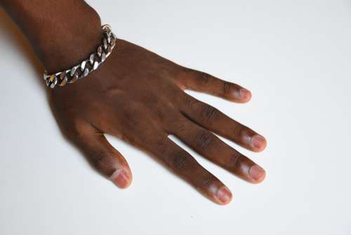 gestural, hand on the table, five fingers, nails, bracelet