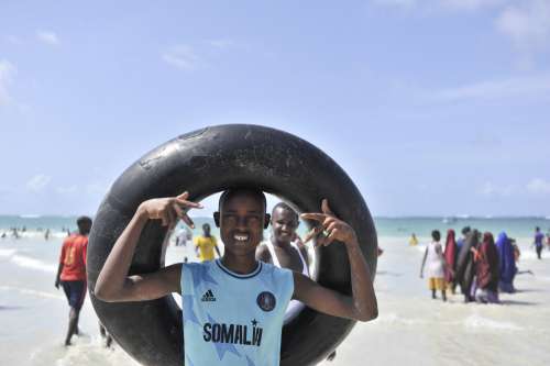 man, people, facial expression, happiness, gestural, inflated inner tube, beach, leisure