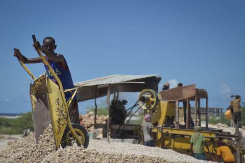 people, man, worker, labor, strength work, wheelbarrow, stone collecting, construction site, facial expression, gestural, stone quarry