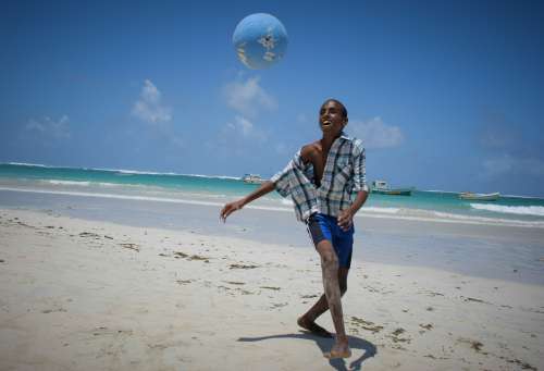 people, boy, child, kid, play, game, beach soccer, gestual, smile, happiness, joy, leisure, hobby, sport, facial expression