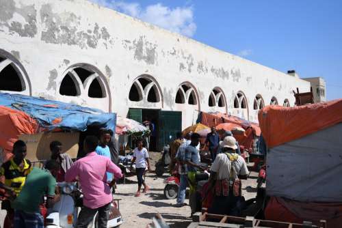 market, customers, sellers, merchants, commerce, men, women, building, people, trade, business center