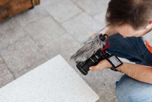 Filmmaker with DSLR Camera Taking Shoots