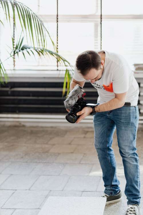 Filmmaker with DSLR Camera Taking Shoots