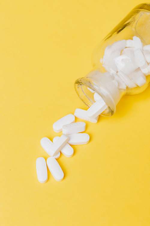 White pills in yellow bottle