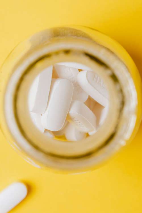 White pills in yellow bottle
