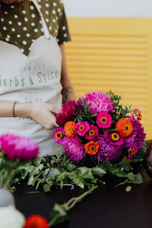 A beautiful woman florist makes a bouquet