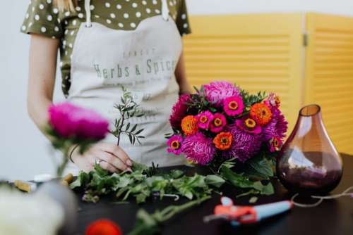 A beautiful woman florist makes a bouquet